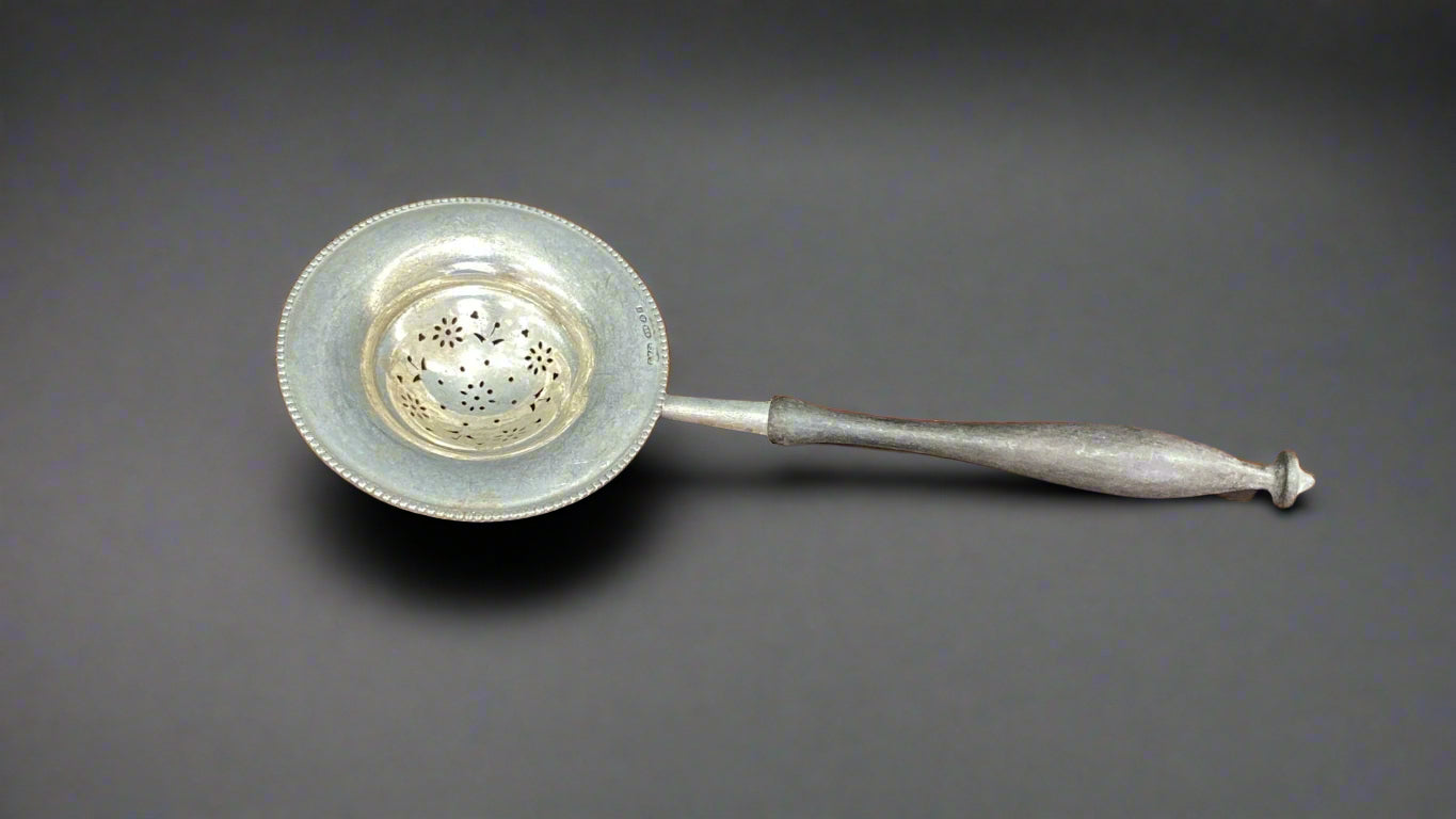 Silver tea strainer with wooden handle made circa 1950