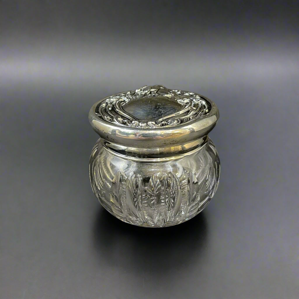 Sterling silver dressing table jar with Reynolds Angel style embossed lid with vacant heart shape escutcheon made in America circa 1920