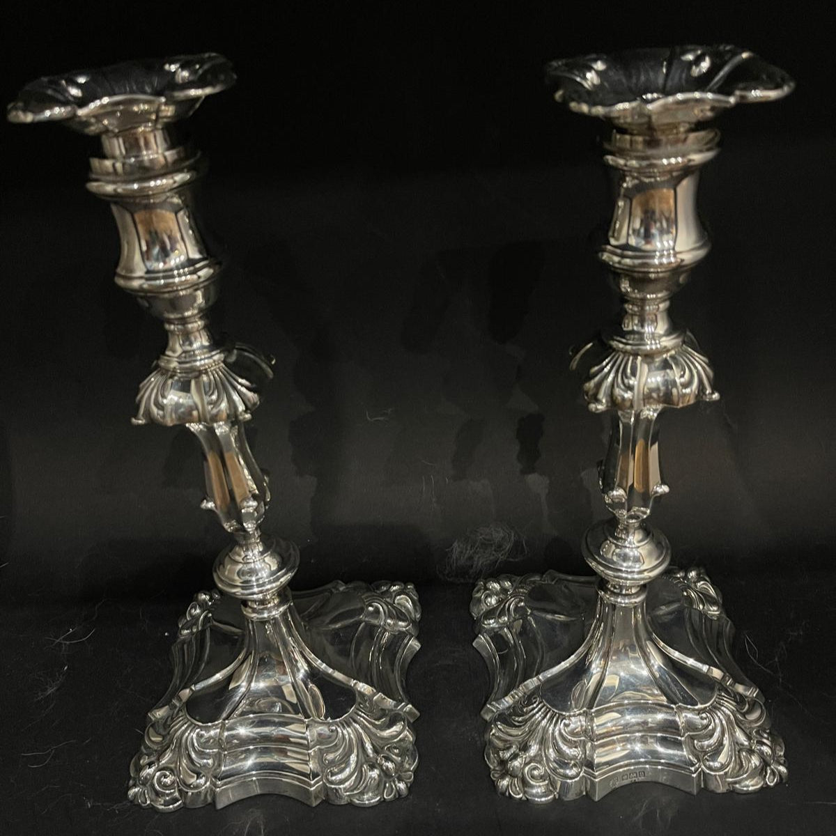 Large pair of silver candlesticks in the early Georgian style with typical panelled bulbous centres, tapering stems and stepped flared square bases made in Sheffield 1912 by Hawksworth and Eyre