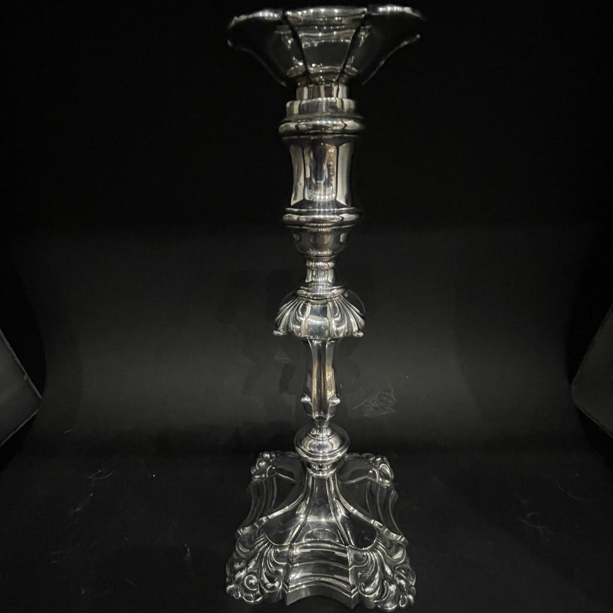 Large pair of silver candlesticks in the early Georgian style with typical panelled bulbous centres, tapering stems and stepped flared square bases made in Sheffield 1912 by Hawksworth and Eyre