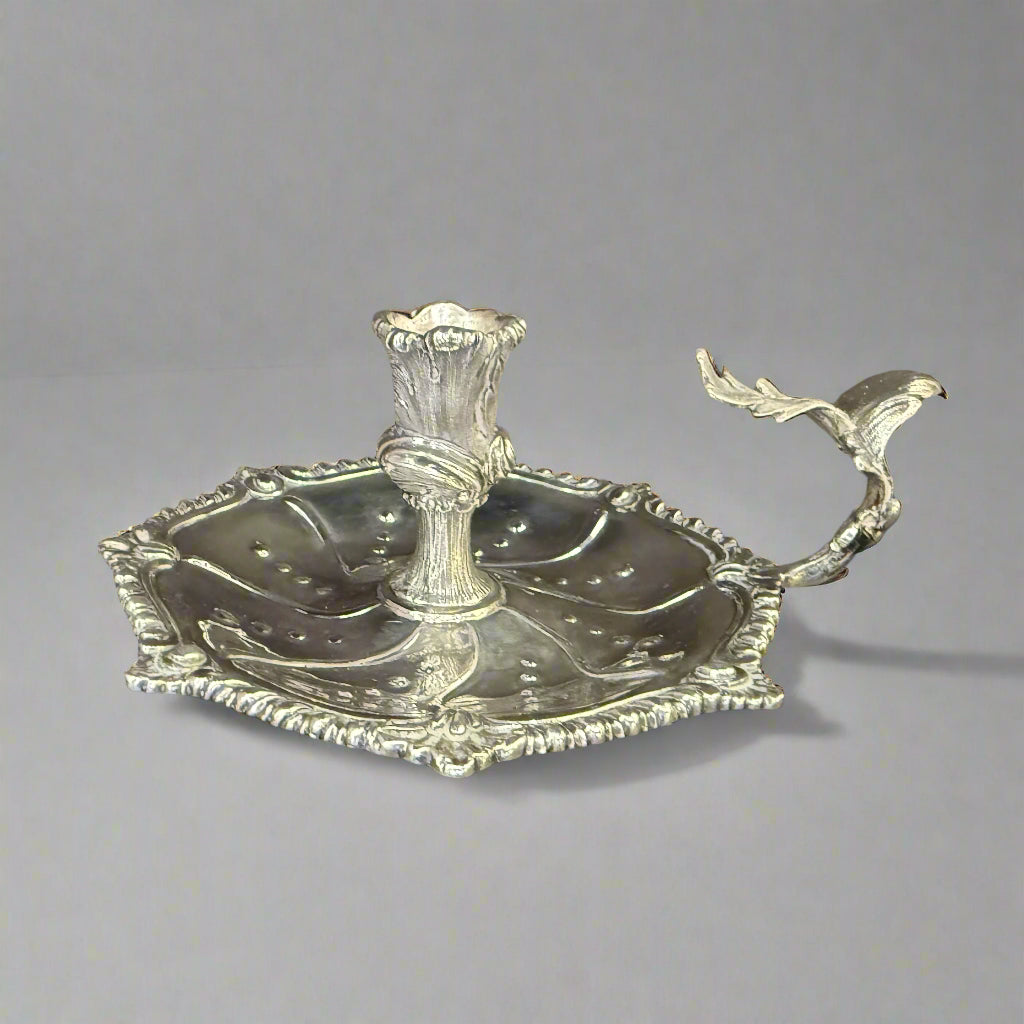 Silver chamberstick of lobed form with gadrooned shell work border and cast oak leaf carrying handle made in London 1949 by Henry Holland 