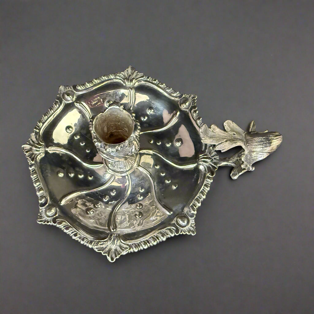 Silver chamberstick of lobed form with gadrooned shell work border and cast oak leaf carrying handle made in London 1949 by Henry Holland 