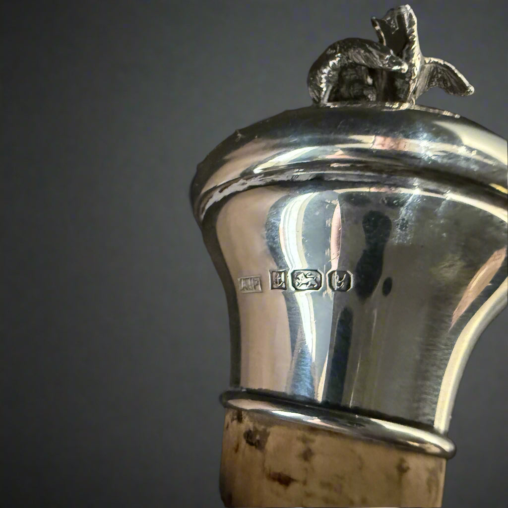 Silver topped bottle stopper decorated with a dog chasing a grouse made in Birmingham 1998