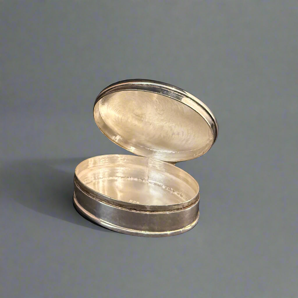 Modern oval silver pill box with bright cut rim made in Sheffield 2004