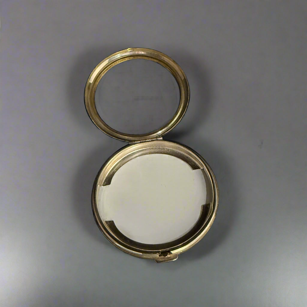 Modern silver compact with machine-turned base and floral top made in London by Harrison Bros