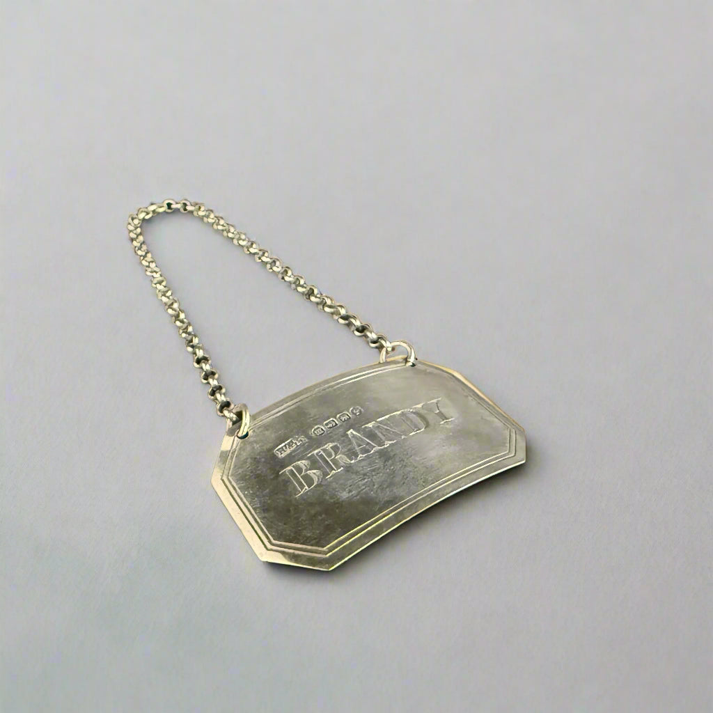 Silver brandy decanter label made in Birmingham 1886 by Hillard & Thomason