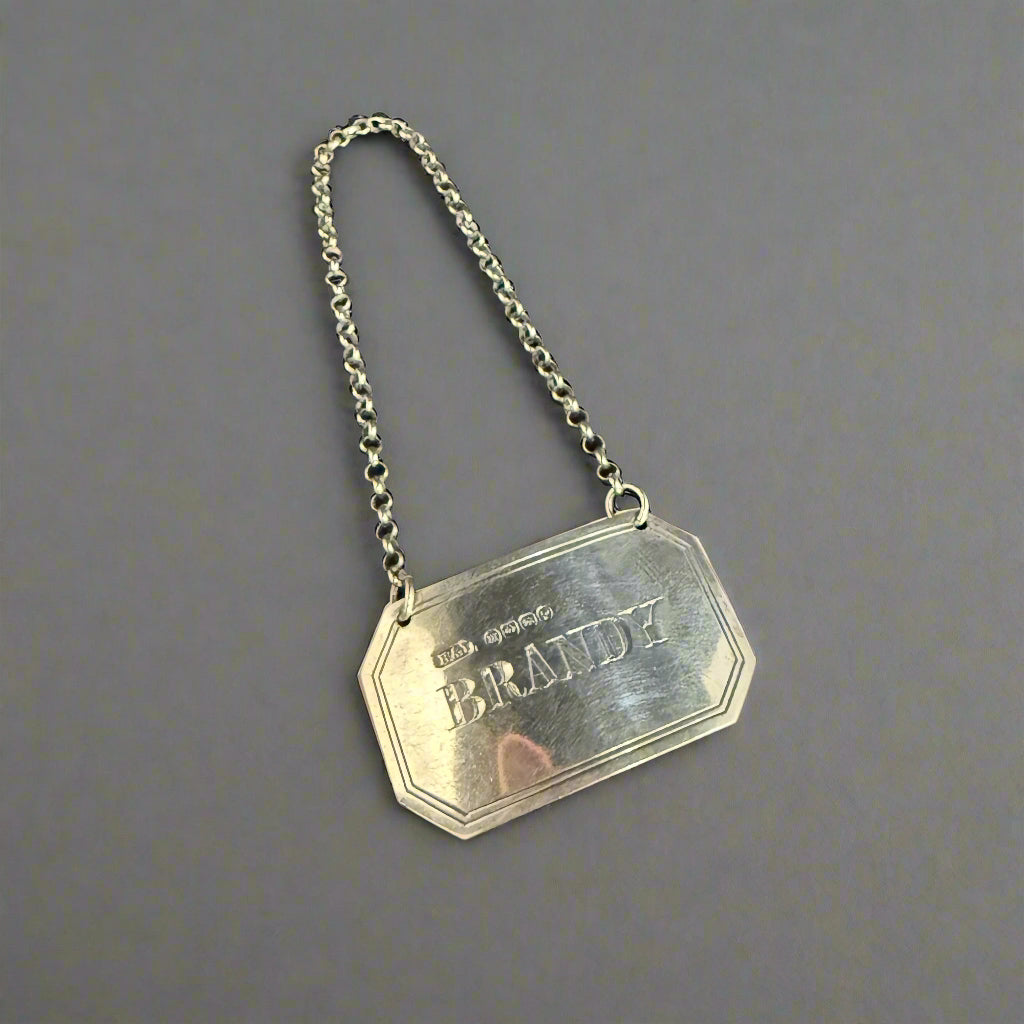 Silver brandy decanter label made in Birmingham 1886 by Hillard & Thomason