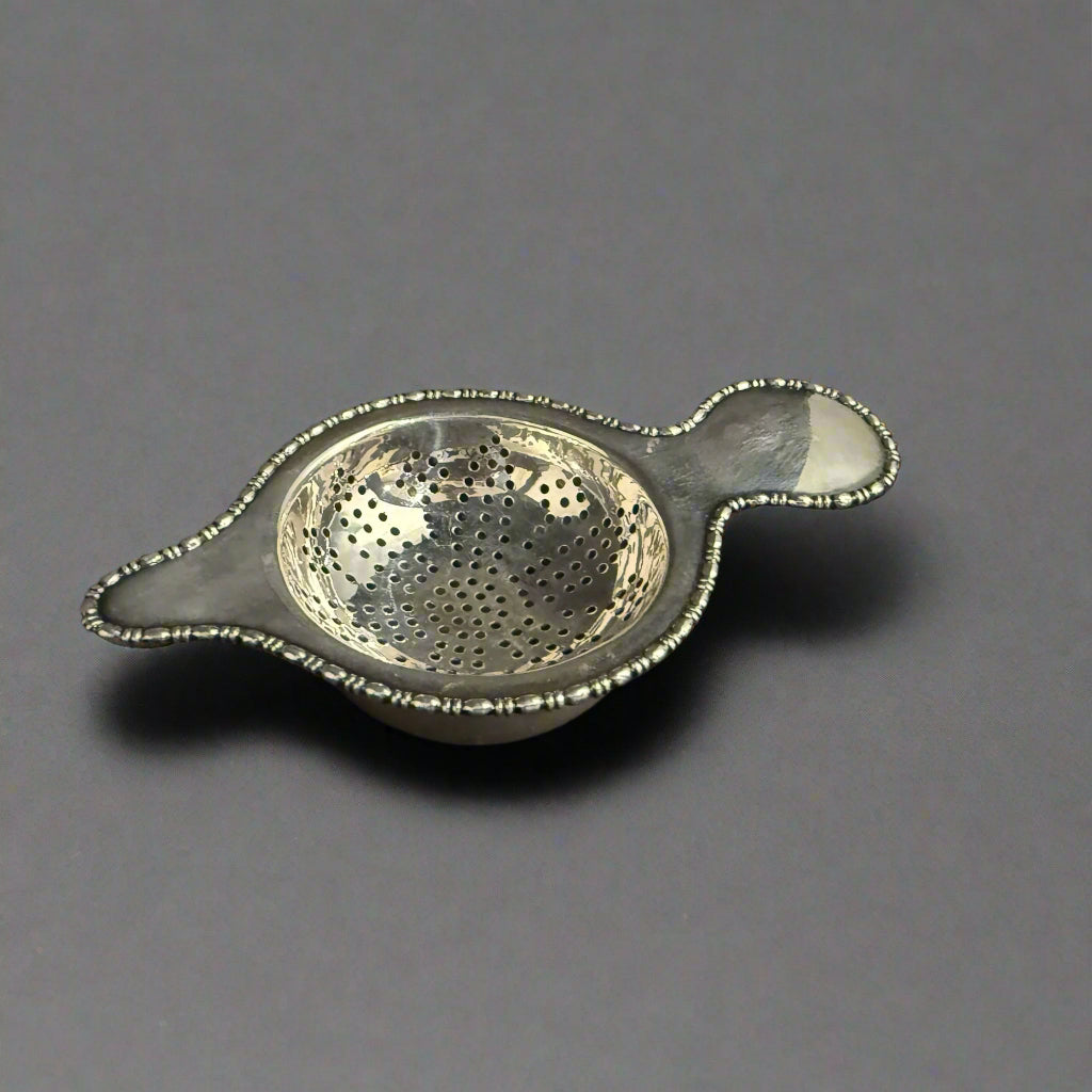 Bead-edged silver tea strainer and bowl made in Sheffield 1937 by Atkin Bros