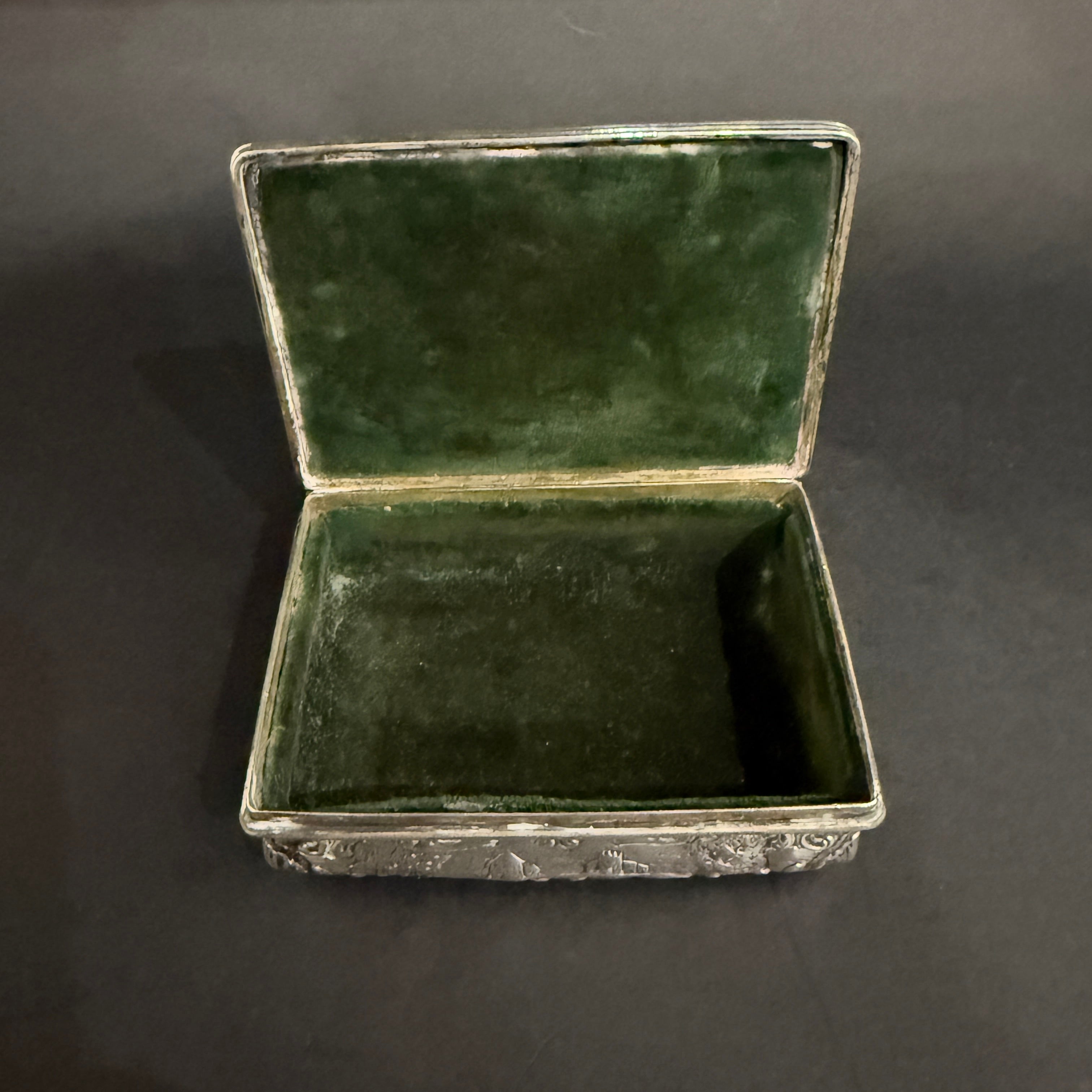 Dutch silver trinket box with green velvet interior and repousee decorations circa 1820