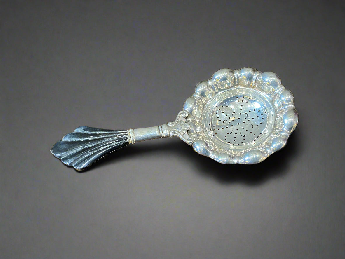 Silver tea strainer with Art Deco bakerlite handle made in Fredicia, Jutlandin, Denmark in 1931 by Carl M Cohr