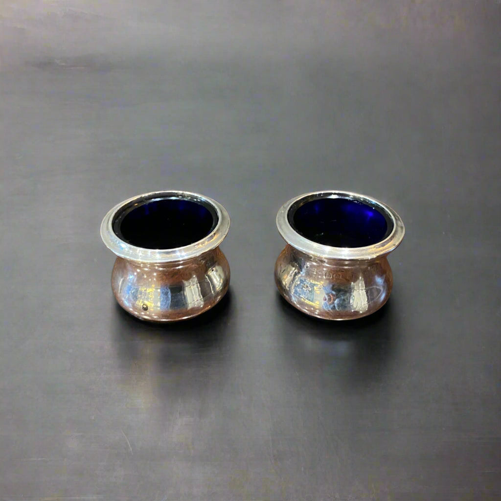 pair of silver salts with blue glass liners