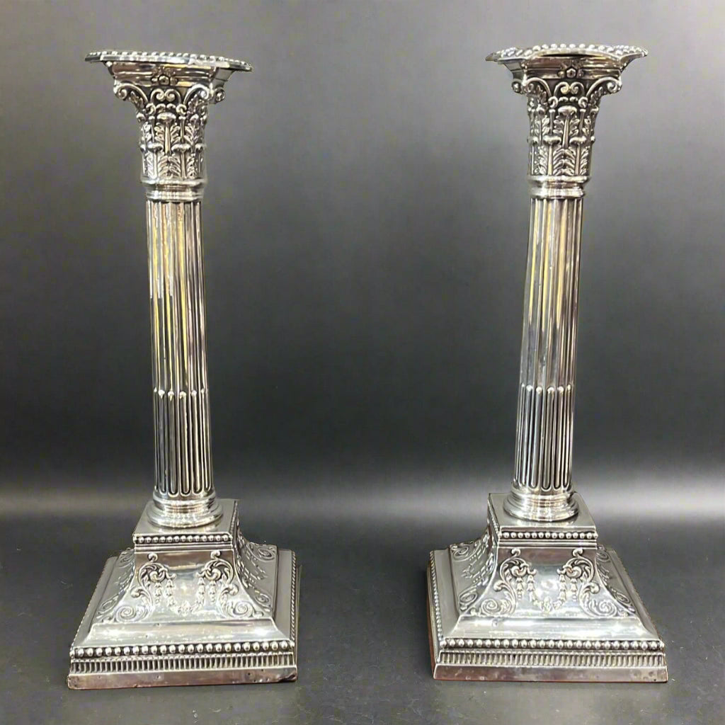 Pair of silver Corinthian column candlesticks on square base with an ornate tapering elevation to the column base made in Sheffield 1900 by James Dixon