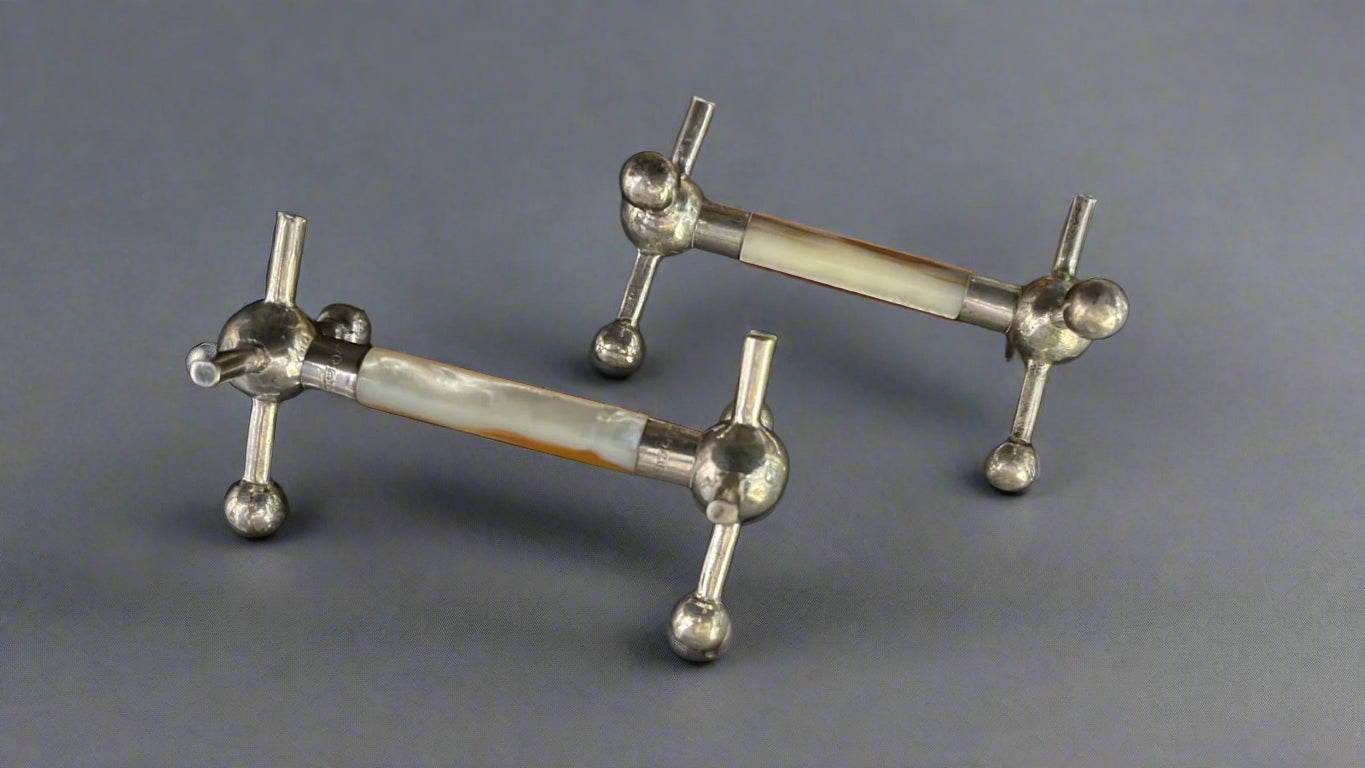 pair of silver mounted mother of pearl knife rests